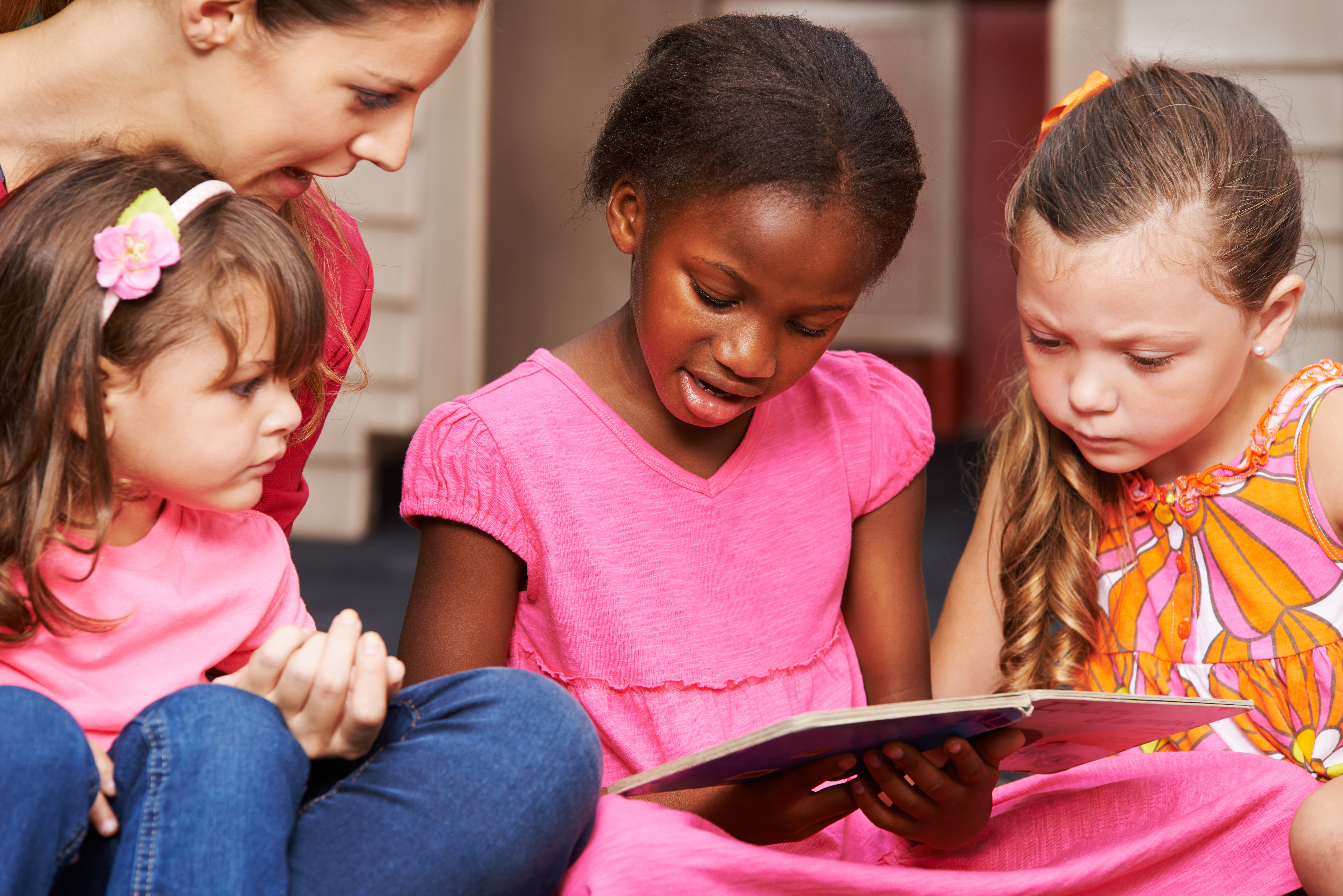 Kinder lernen lesen mit Erzieherin